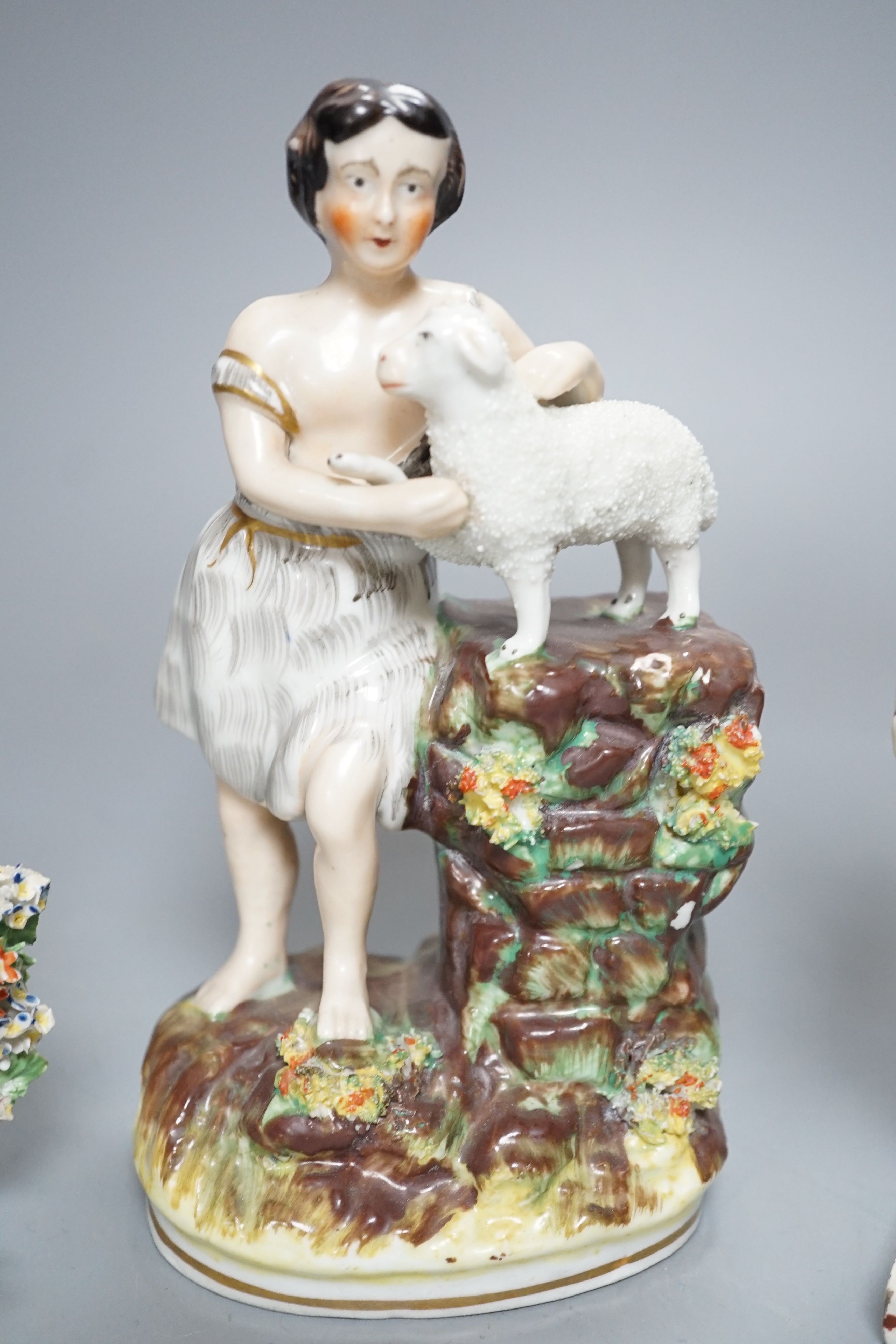 A Chelsea-Derby bocage figure, 16cm, 19th century pearlware figure of Cupid disguised and one other Staffordshire figure